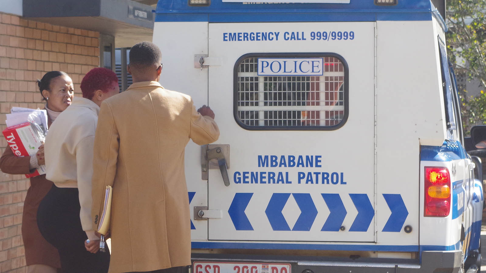 Hlobsile Mbetse (between the police officers) boarding a police van after her remand. (Pic: Sibusiso Shange)